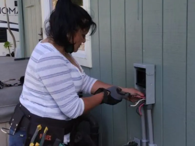 Licensed electrician wiring an exterior subpanel in Merrill